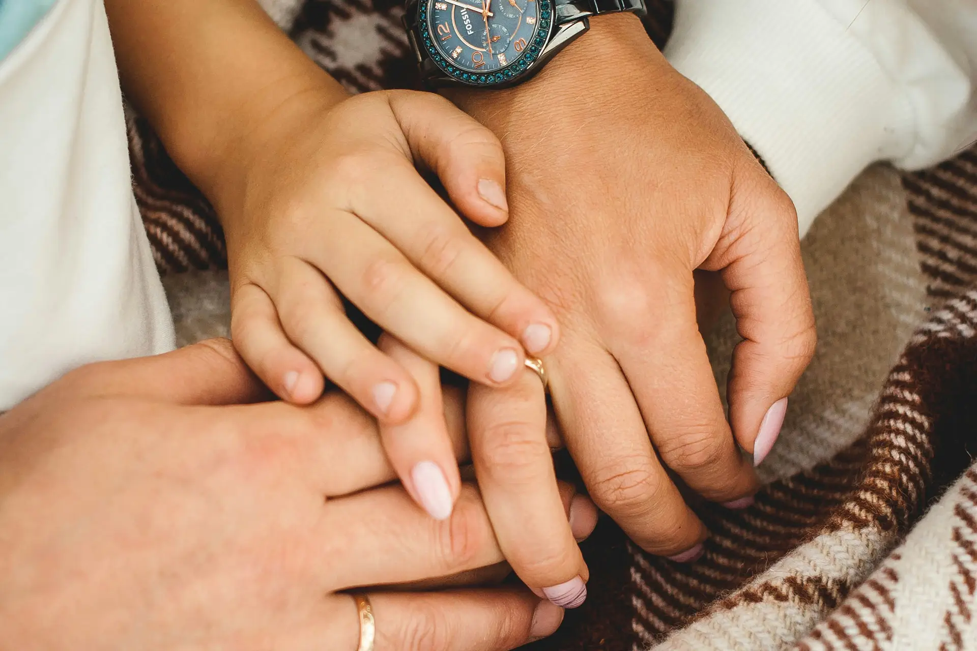 Hands of parents and child