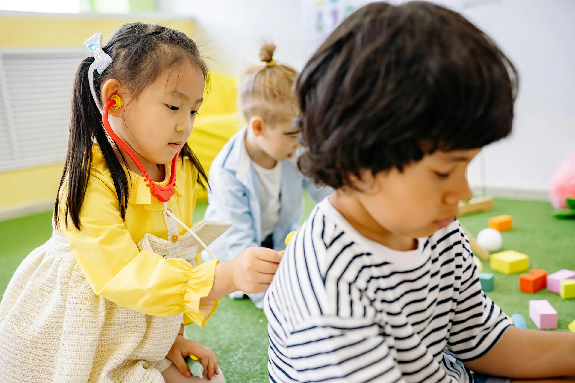 Children playing with doctor toys