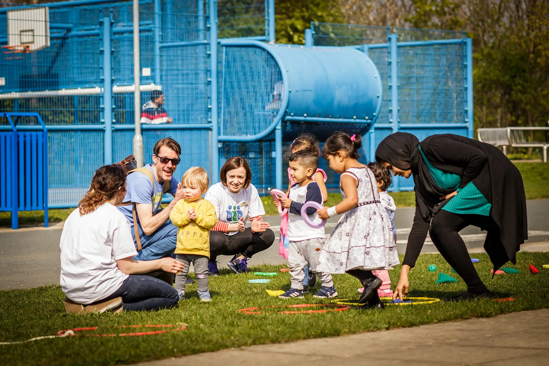 Children playing in playground with hulahoops