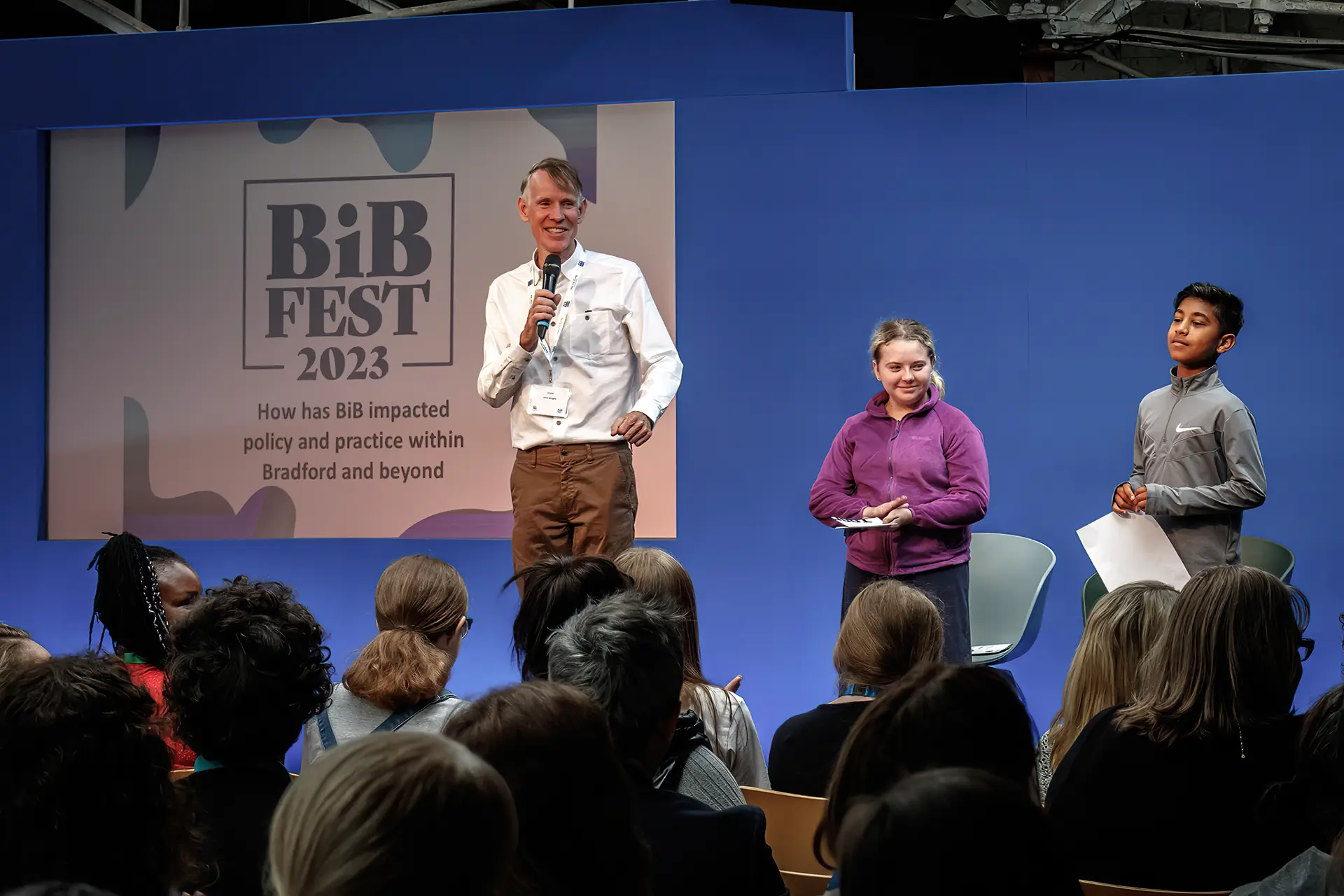 Professor John Wright presenting with two younger volunteers at BiB Fest 2023