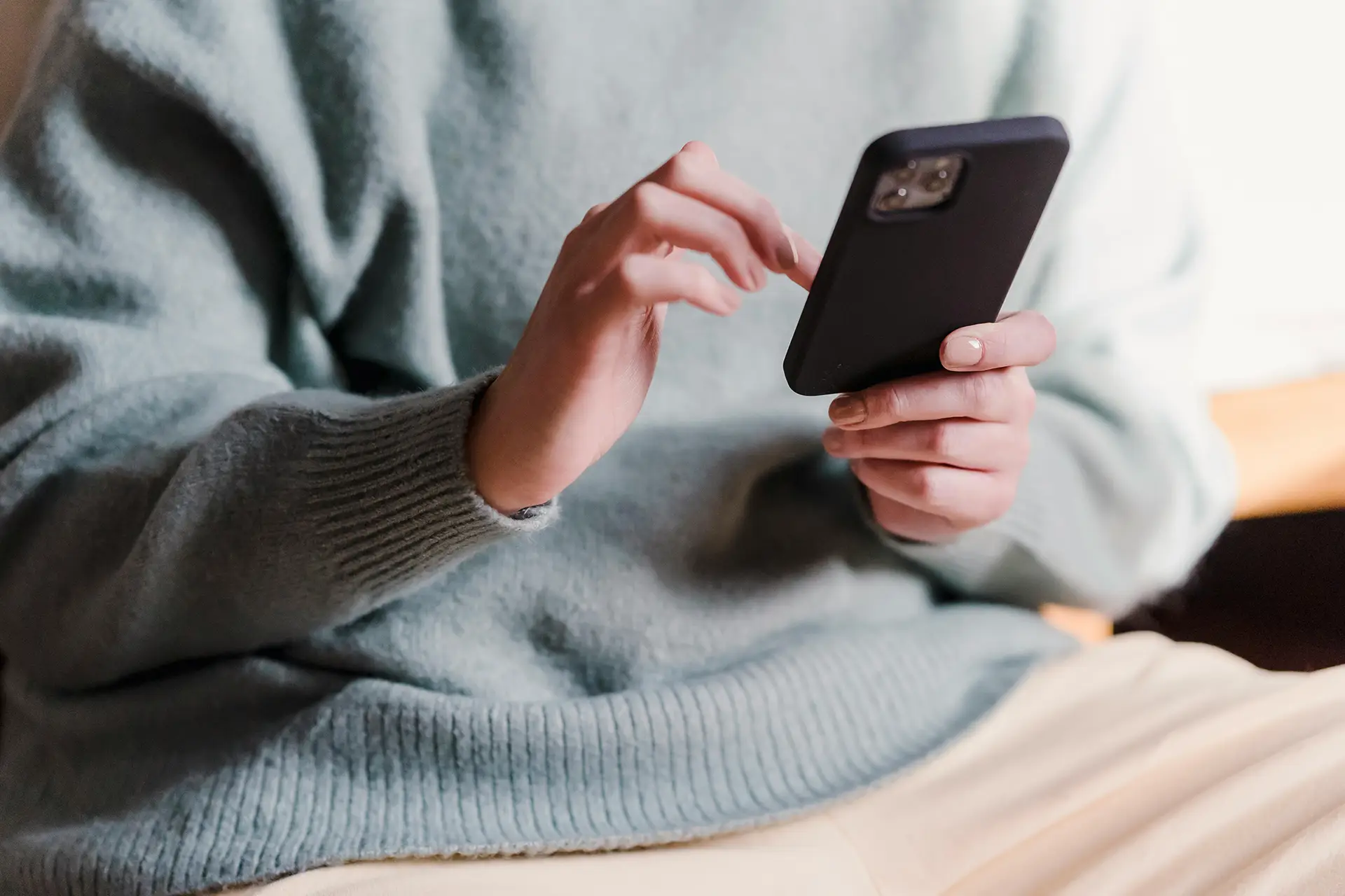 Woman scrolling through iPhone